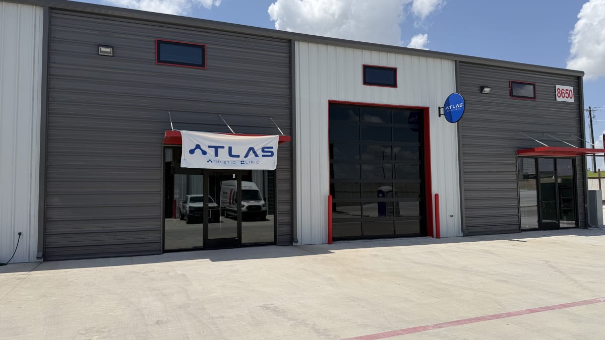 Atlas Athletic Clinic storefront with banner and blade sign, July 12, 2026
