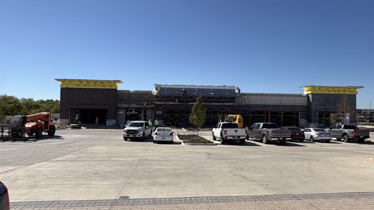 Shops C masonry facade underway, October 11, 2026