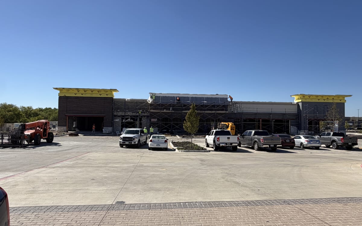Shops C masonry facade underway, October 11, 2026