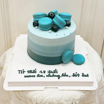 Bánh kem thôi nôi bé trai macaron xanh