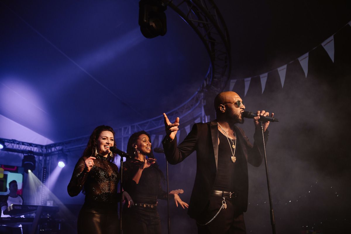 Jam Hot singers on stage at a festival