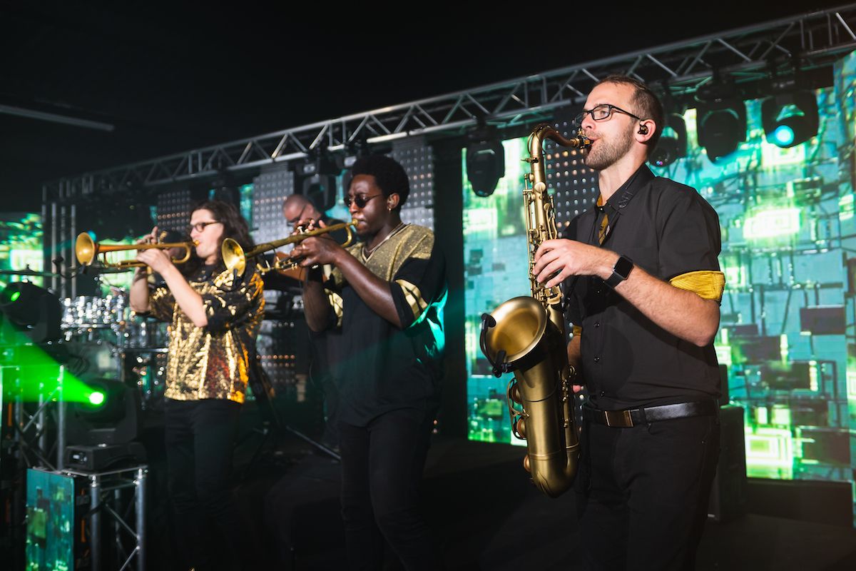 Jam Hot horn section perform on stage