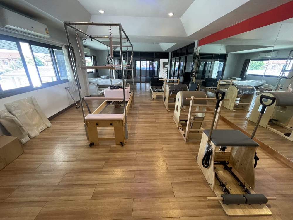 The studio floor: Full Tower Reformer, barrels and chairs