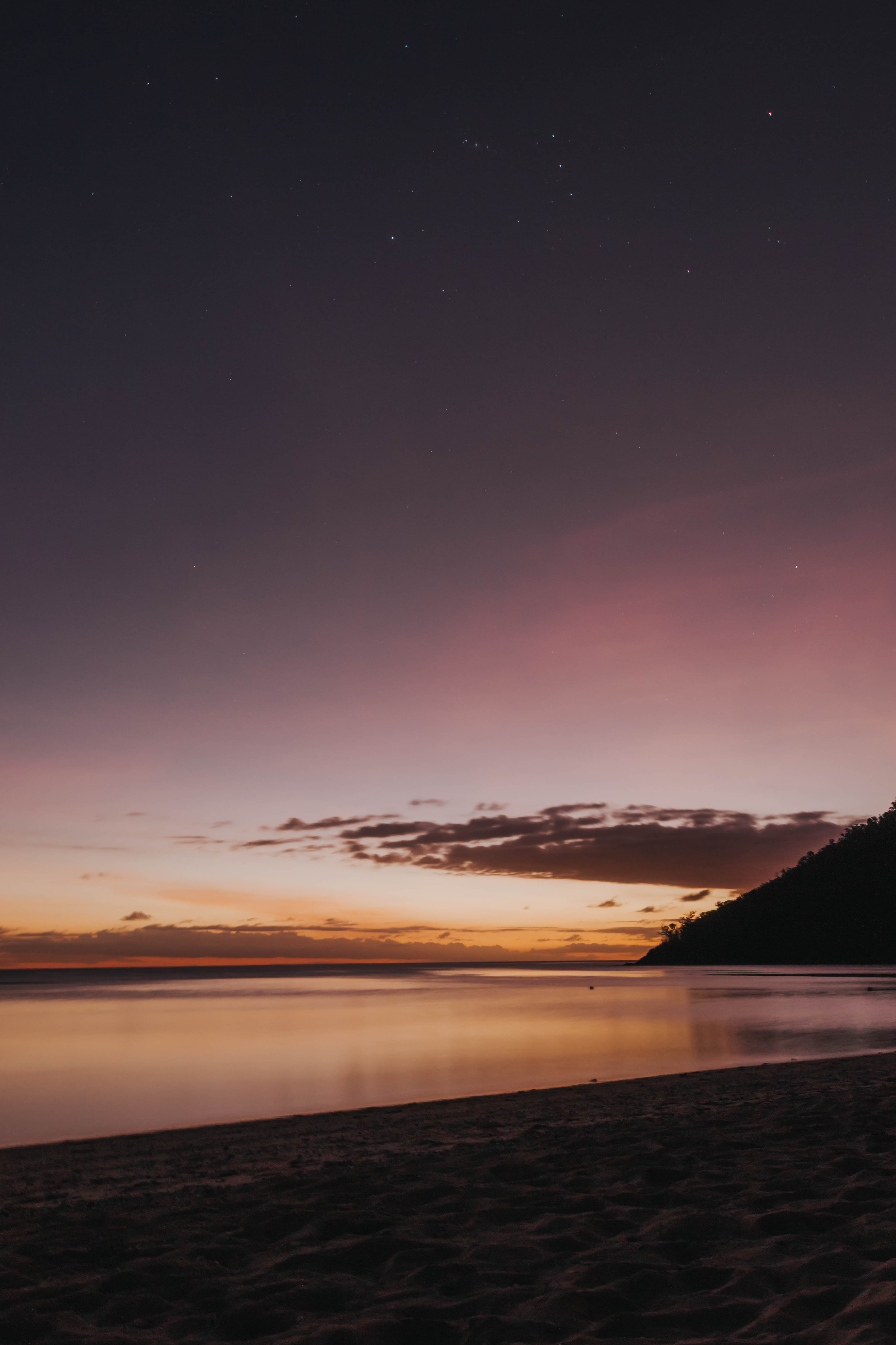 A beach sunset with a pink sky