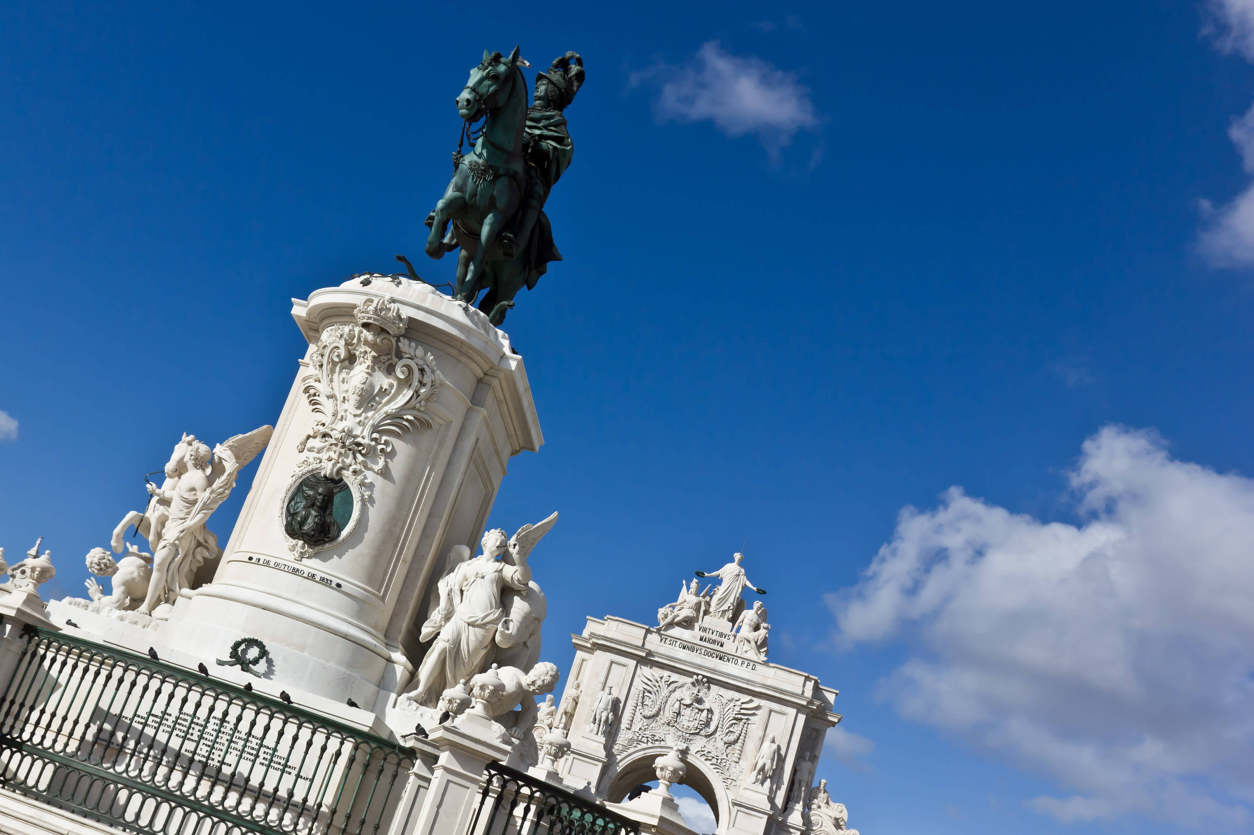 Large statue in the middle of Lisbon with arch behind