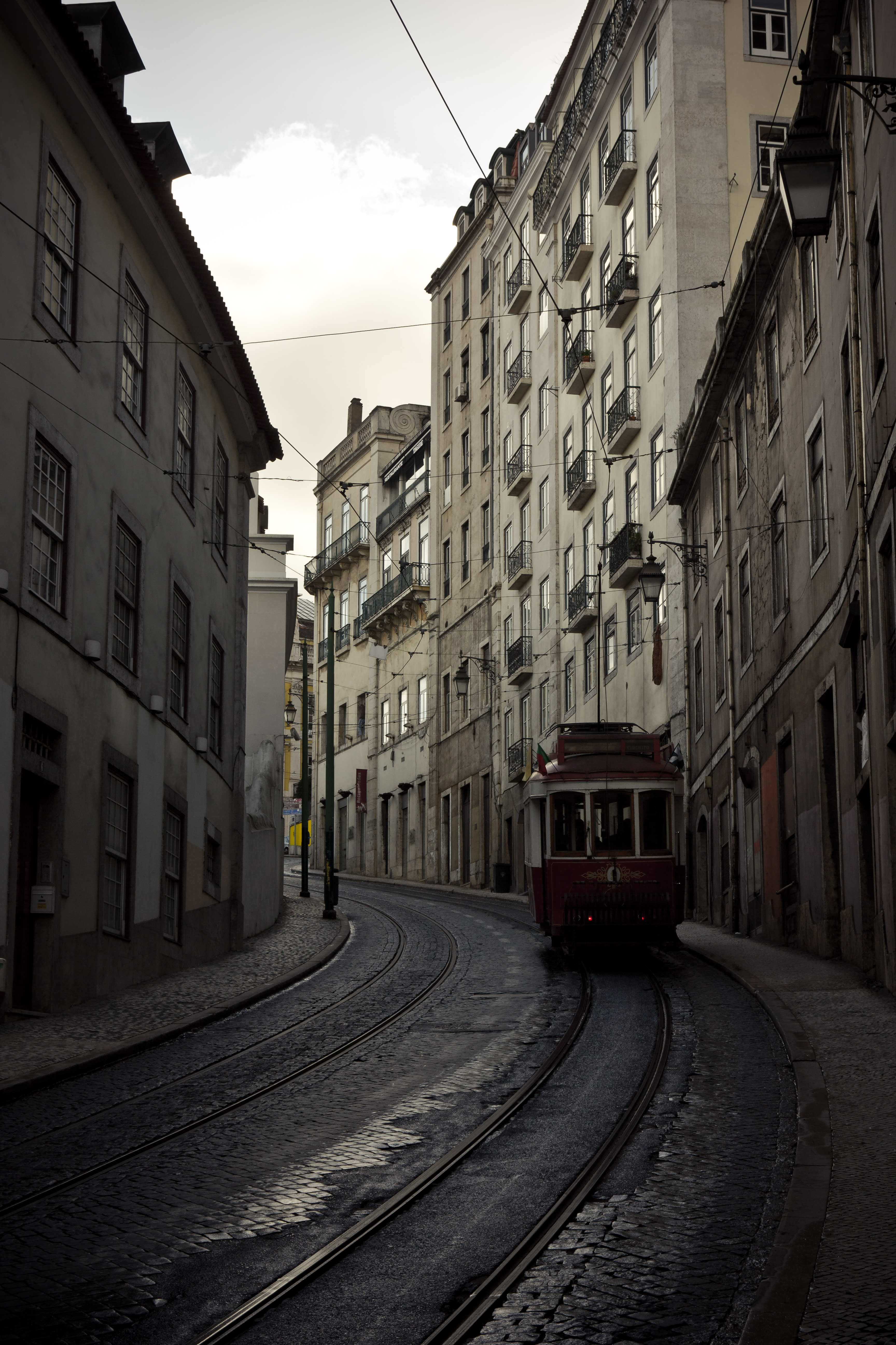 Tram going up curved Lisbon street