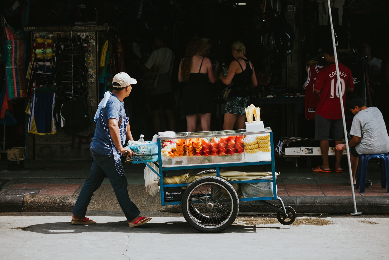 Man pushing a food trolley in the street