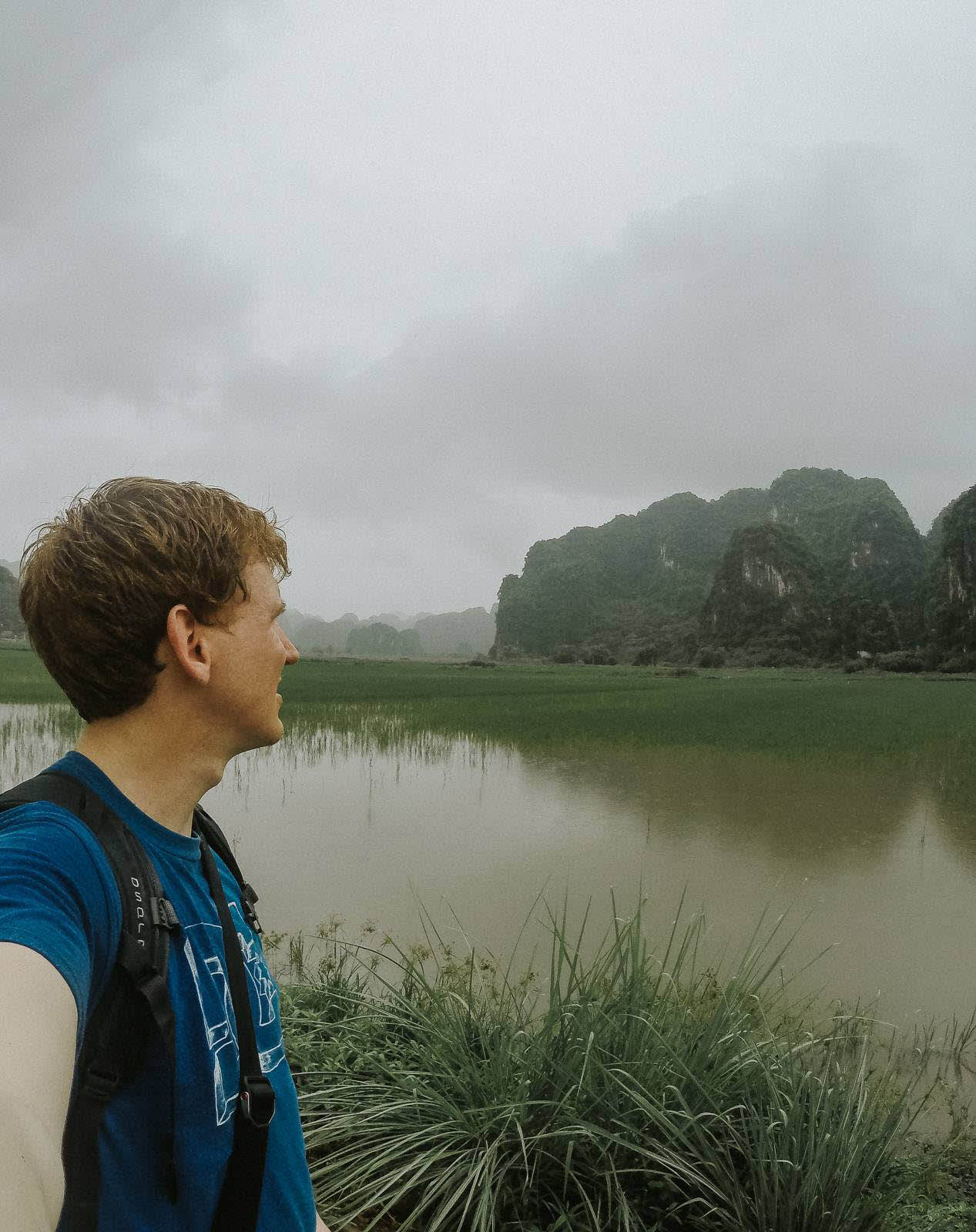 Me looking across some water at some hills