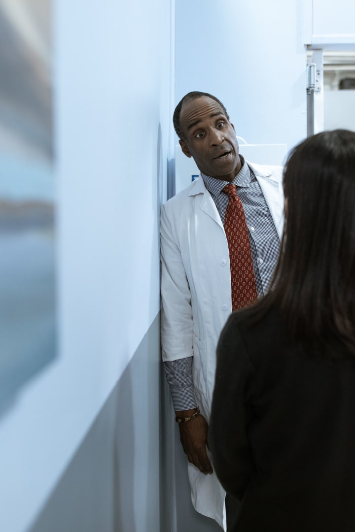 Doctor speaking with a patient during a non-graphic clinical consultation.