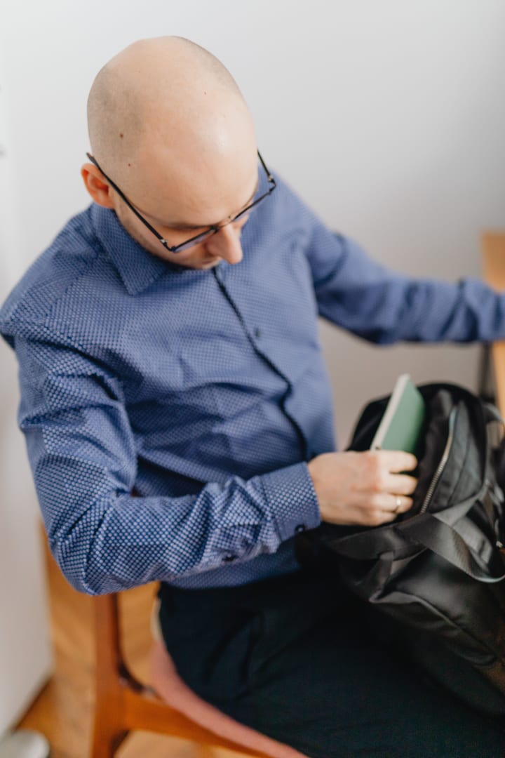 Traveller packing essential belongings into a bag before a journey.