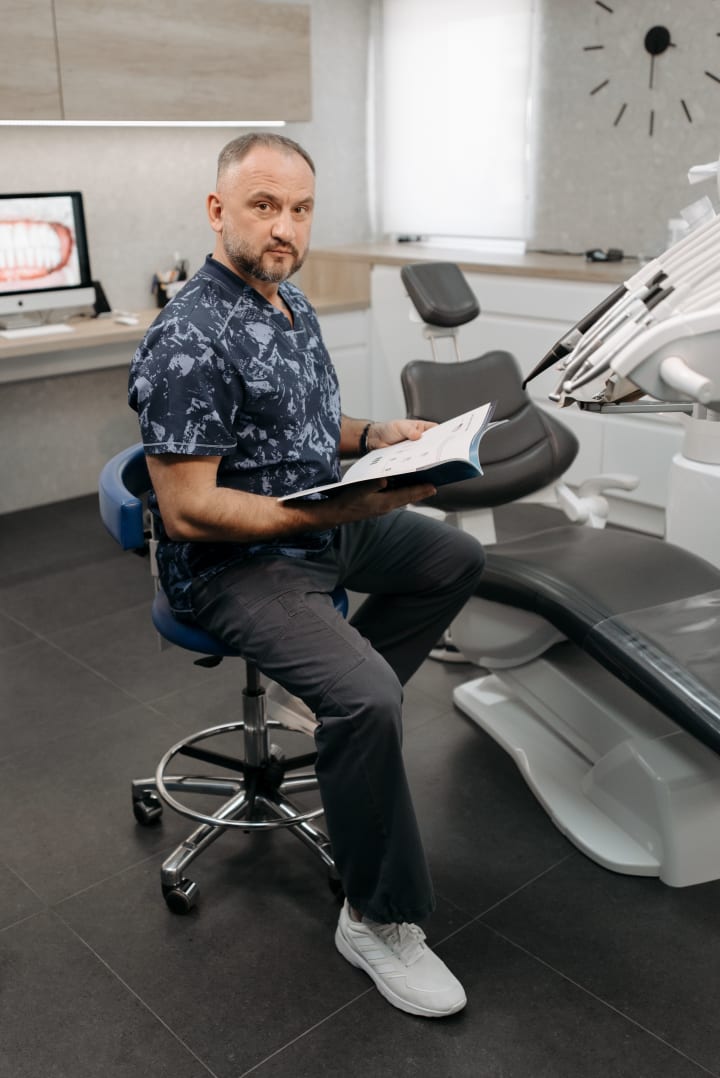 Dentist reviewing patient records in a modern dental clinic.