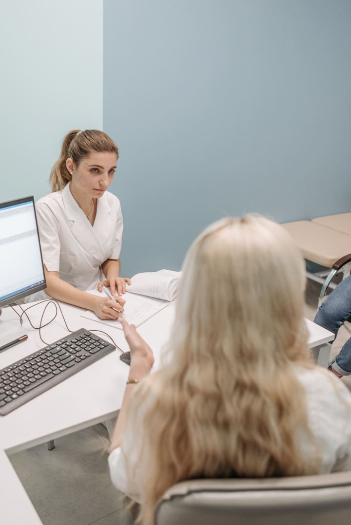 Doctor consulting with a patient in a modern medical office.