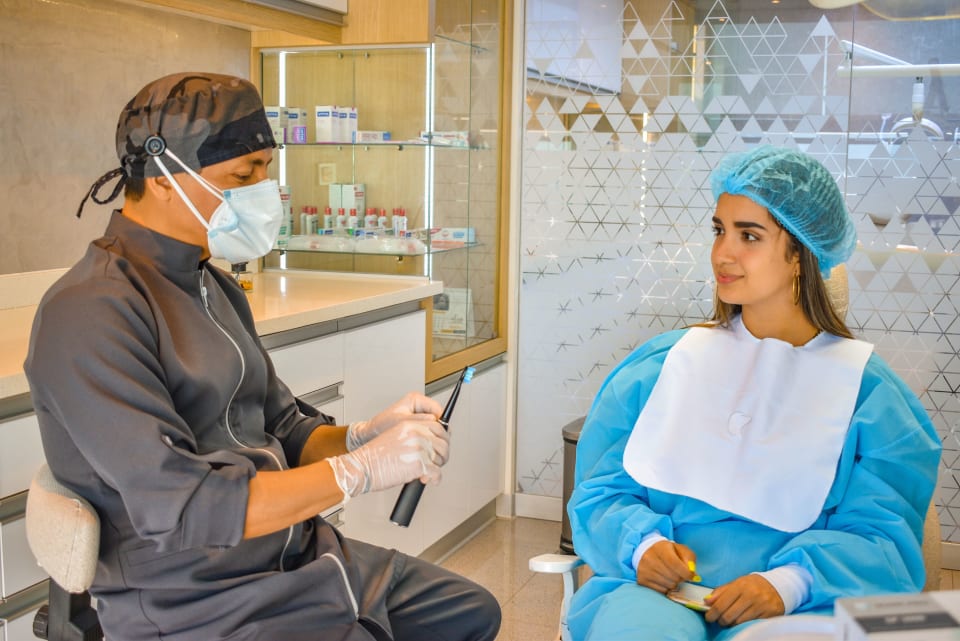 Dentist consulting with a patient in a modern dental clinic.