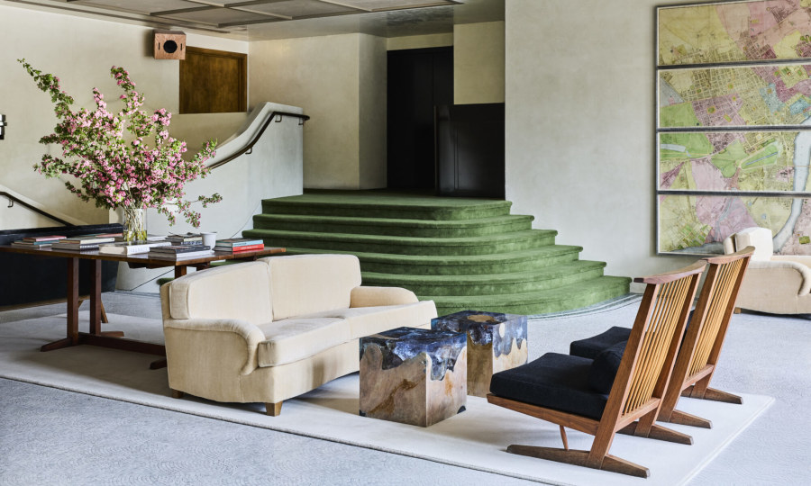 St Clement hotel lobby interior, brutalist concrete softened by warm furnishings