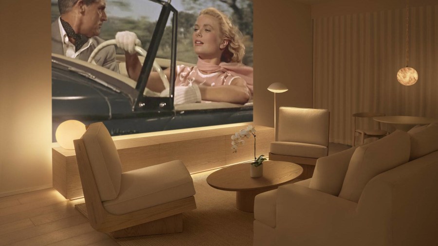Public West Hollywood guest room with 11-foot projection screen and warm minimalist design in ash wood and cream tones
