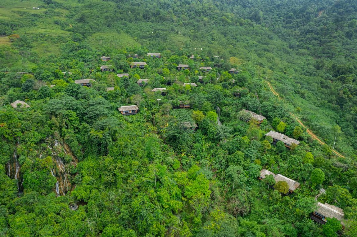 Aerial view of Avana Retreat villas nestled into the hillside with cascading waterfall