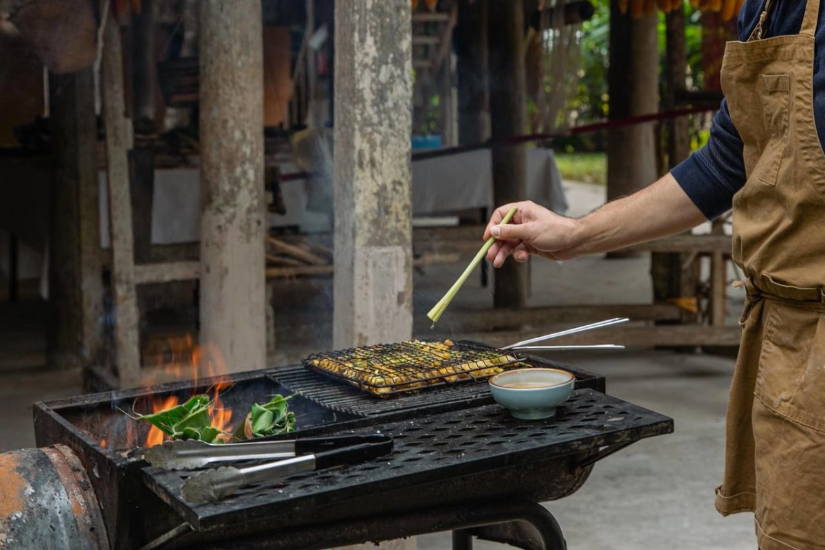 Chef grilling with lemongrass over open flame at Avana Retreat