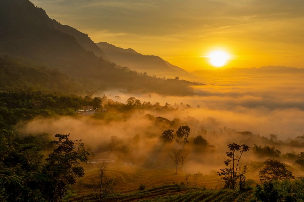 Golden sunrise over misty Mai Chau valley at Avana Retreat