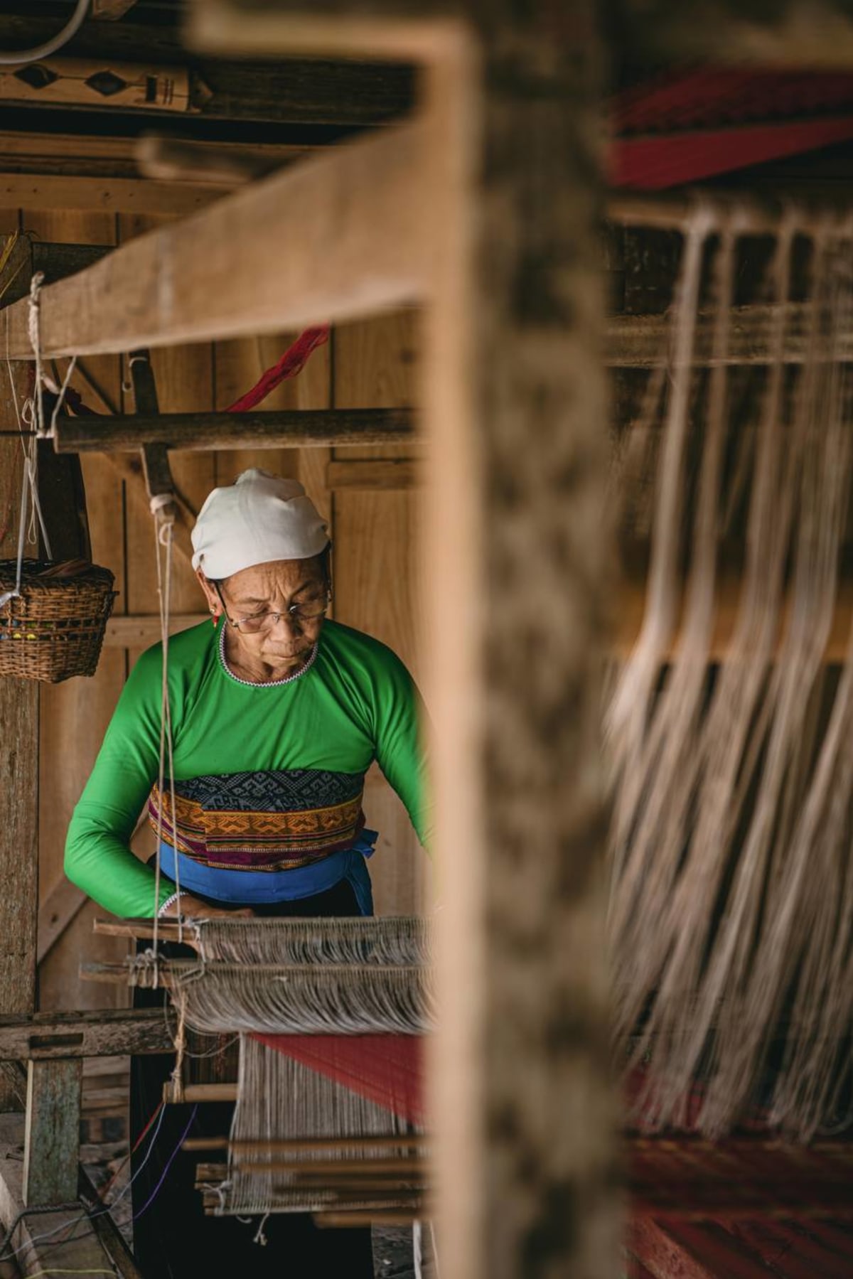Thai ethnic artisan weaving at traditional loom at Avana Retreat