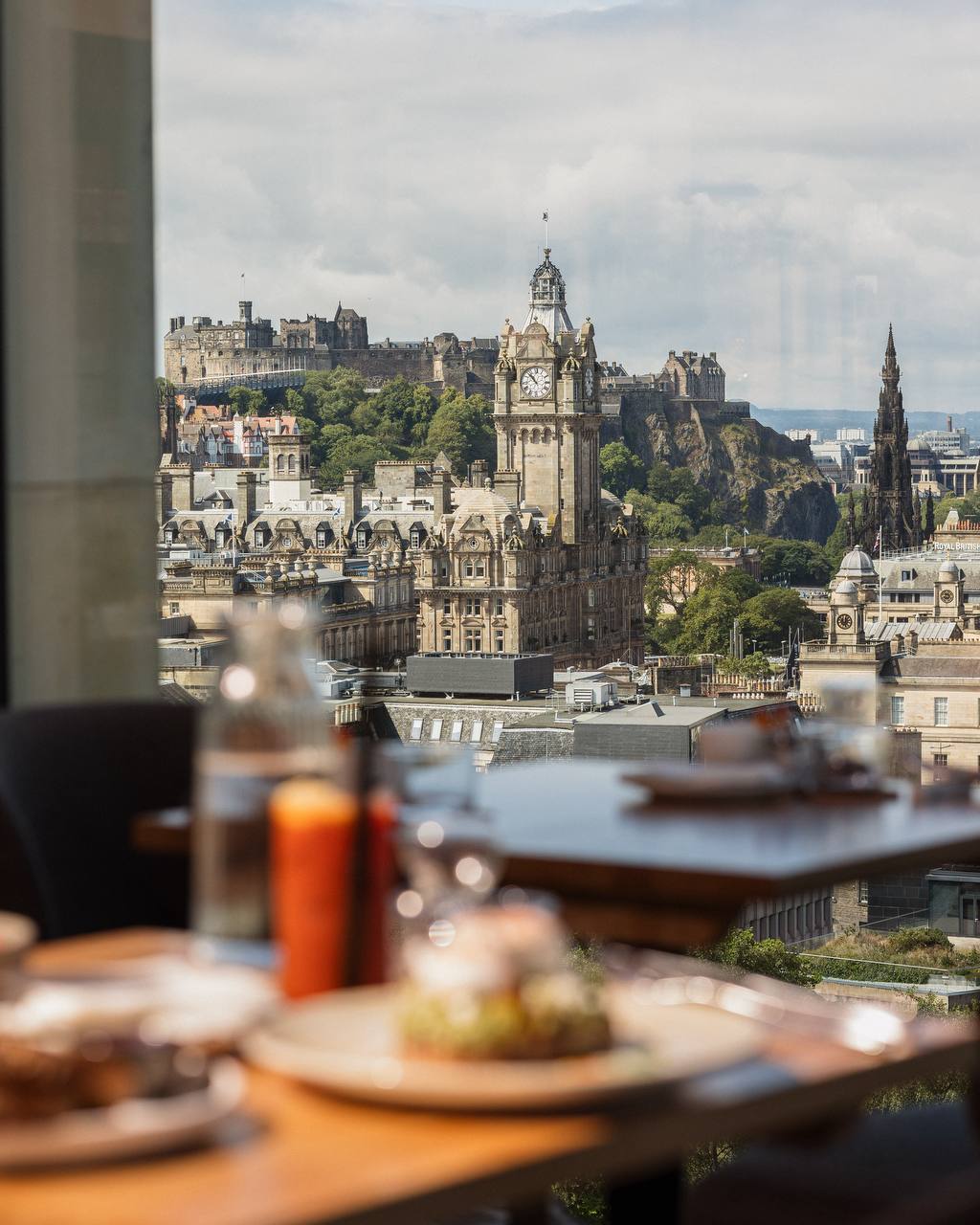 View of Edinburgh Castle through the window from inside Cafe Calton