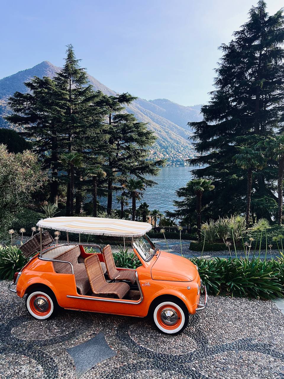 Vintage orange Fiat Jolly overlooking Lake Como at Passalacqua