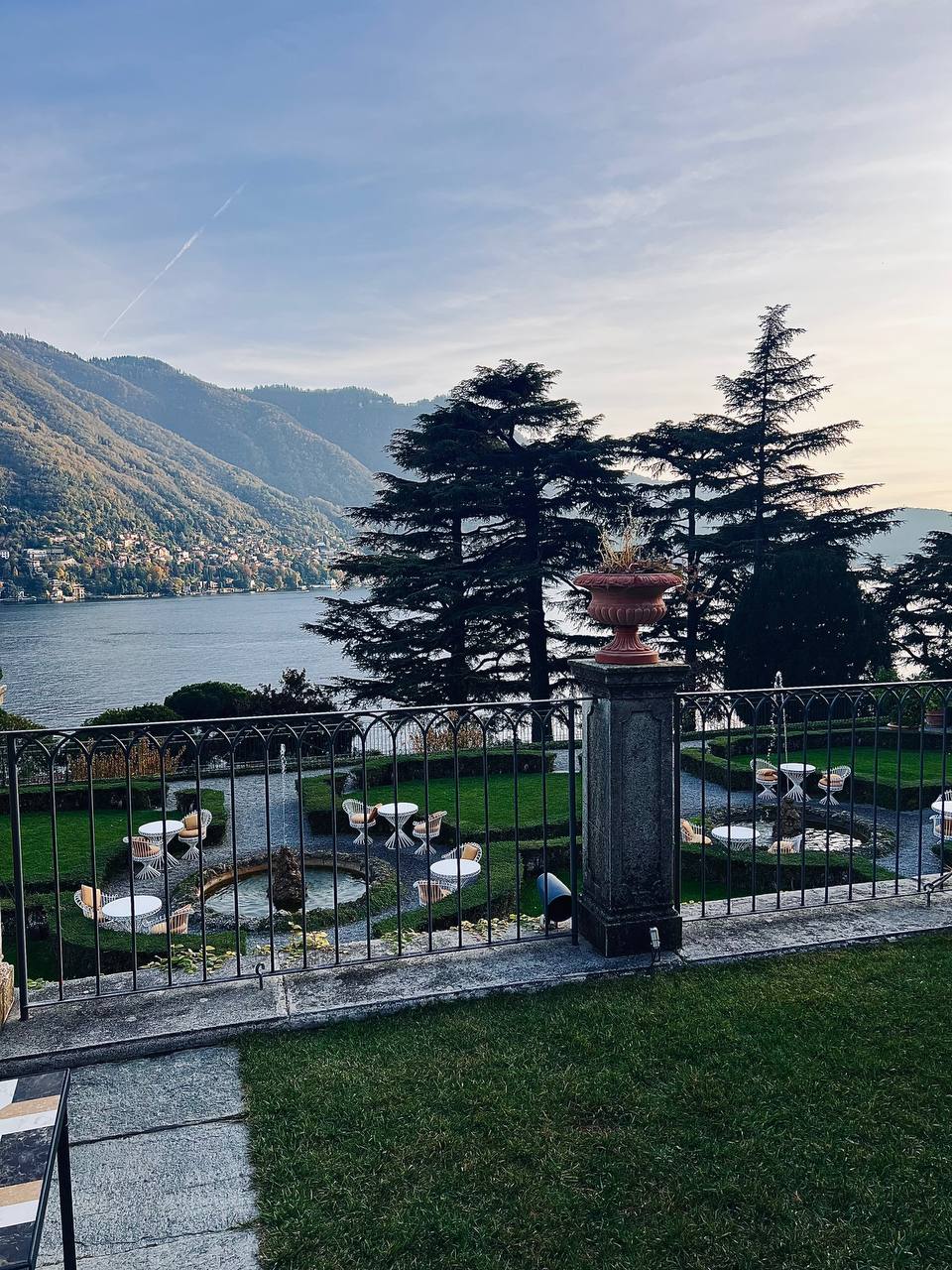 Garden terrace with white tables overlooking Lake Como at Passalacqua