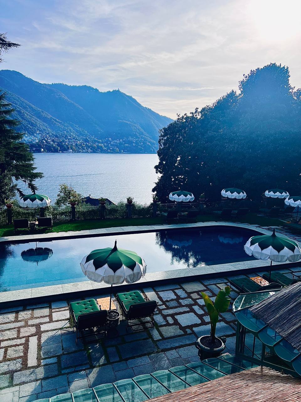 Infinity pool with scalloped umbrellas overlooking Lake Como at Passalacqua