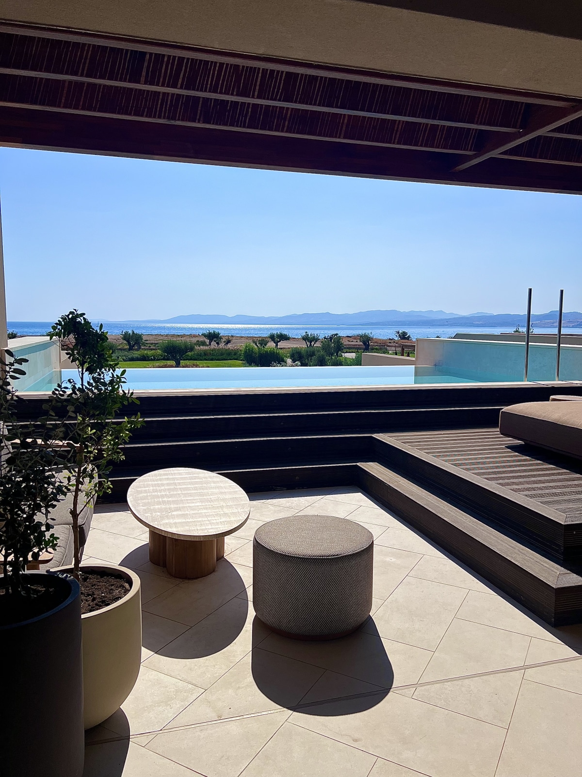 Terrace with infinity pool and panoramic coastal view at Amoh Rhodes