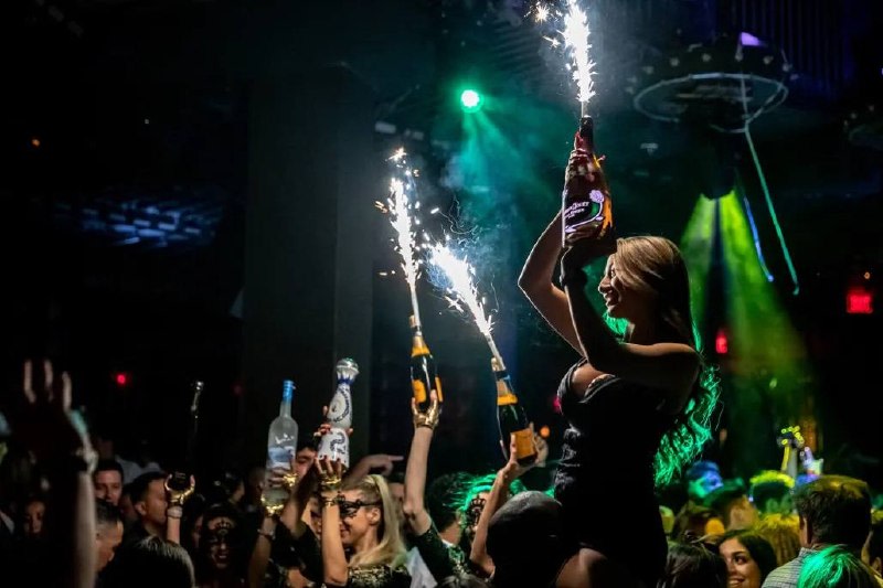 Nightclub scene with bottles and sparklers
