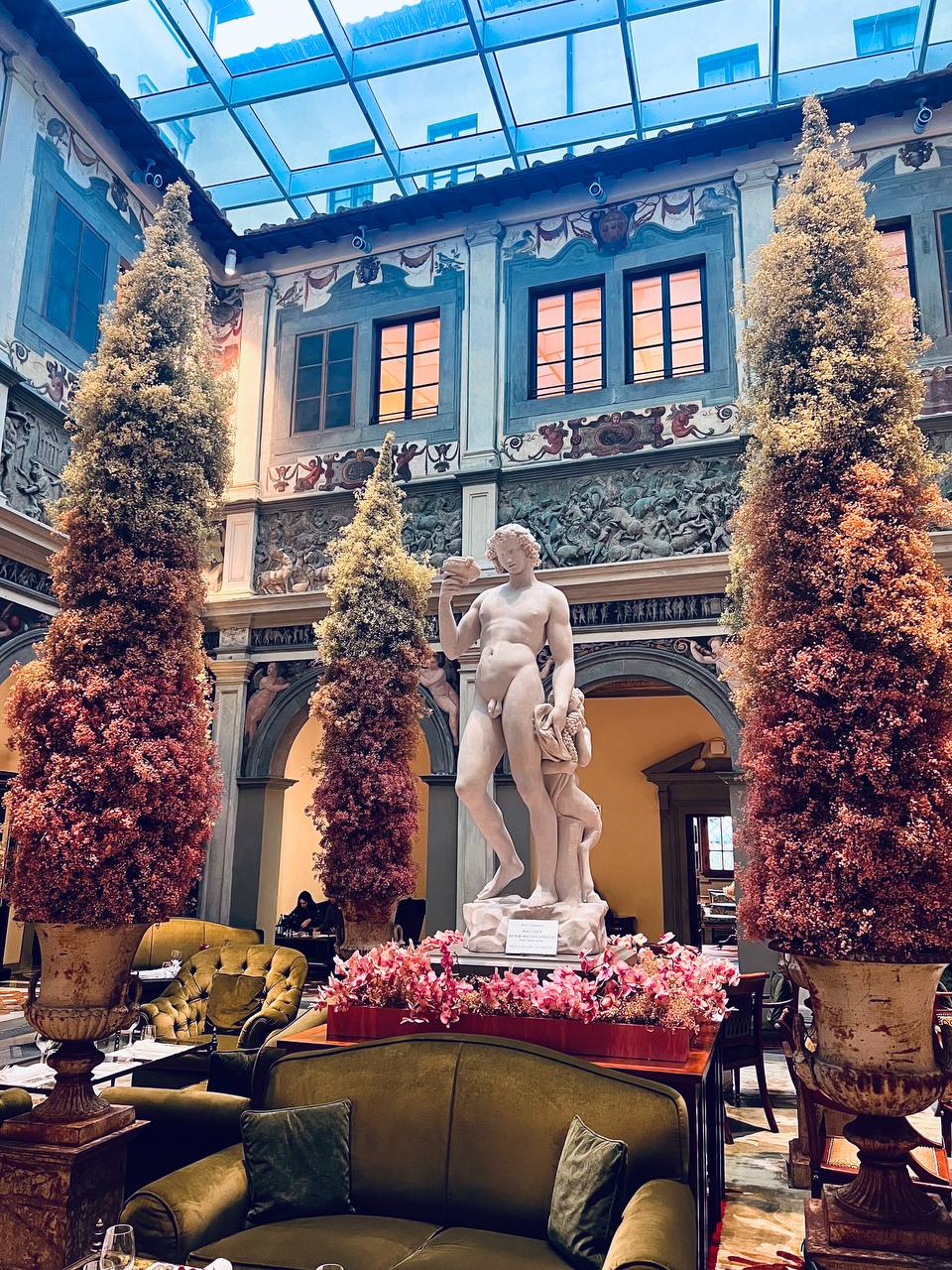 Lobby atrium from above with Bacchus statue centrepiece and pink orchids