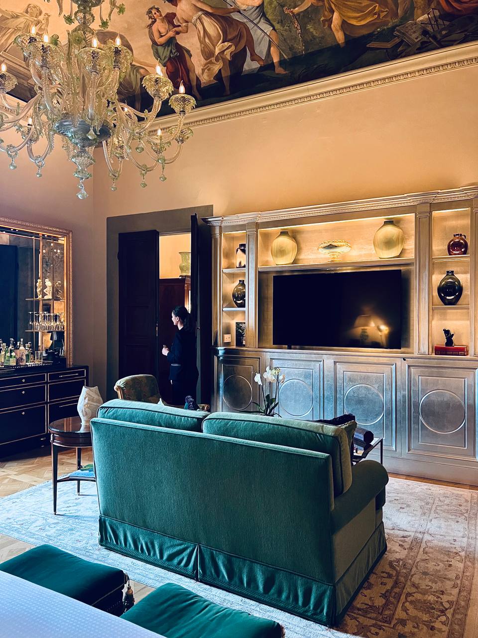 Suite living area with bar cabinet and Murano chandelier