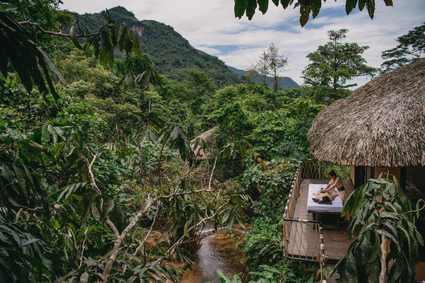 Spa deck with treatment table overlooking river and jungle at Avana Retreat