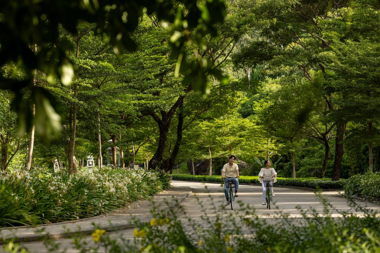 Cycling through the resort grounds beneath tropical canopy