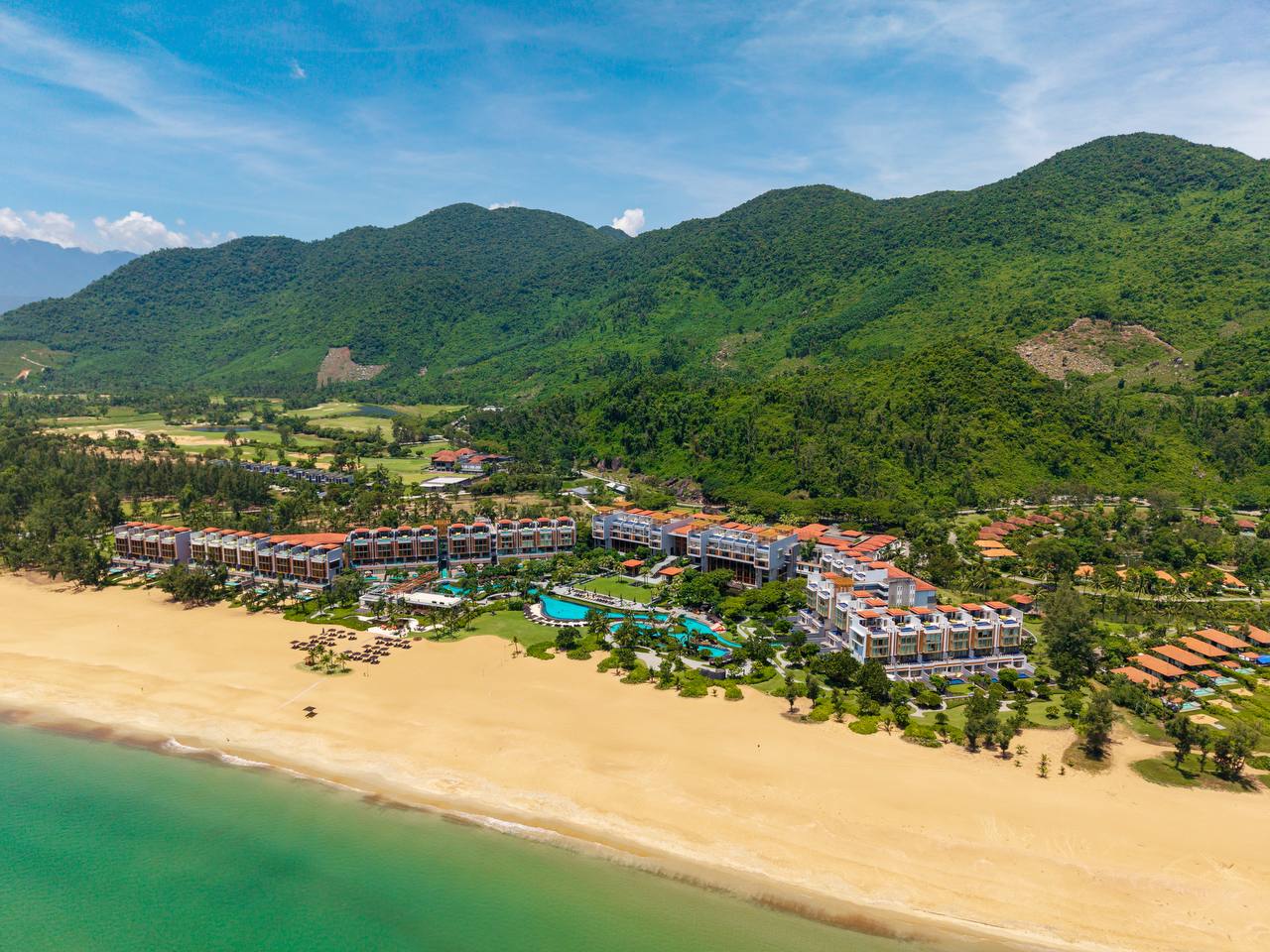 Aerial view of Angsana Lang Co resort between beach and mountains