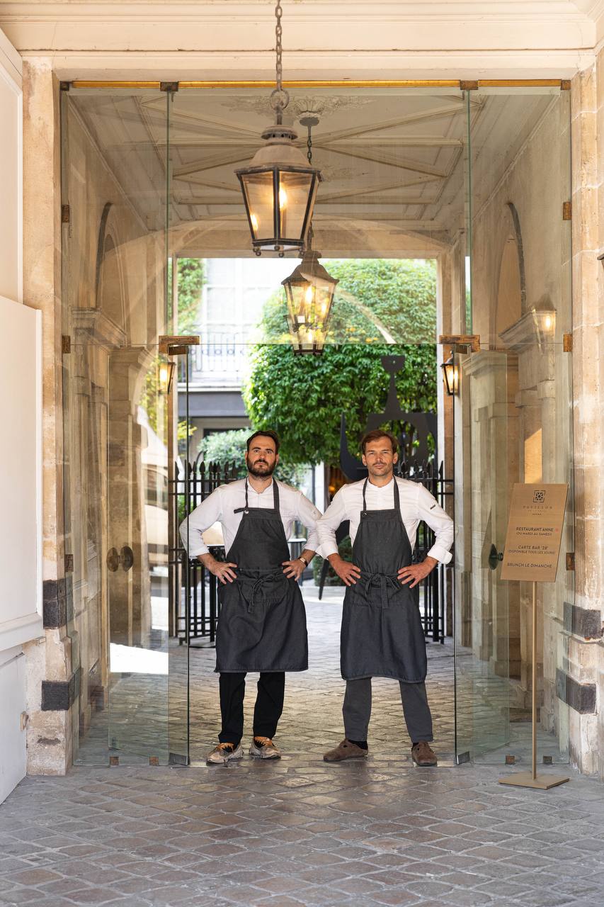Chefs at the entrance to Pavillon de la Reine