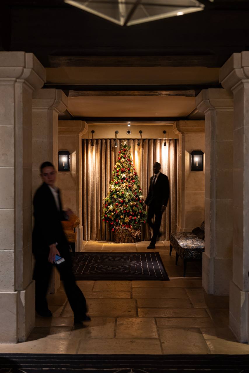 Stone corridor with festive decorations at Pavillon de la Reine
