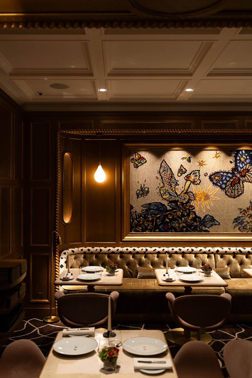 Restaurant Anne interior with butterfly tapestry and tufted banquette