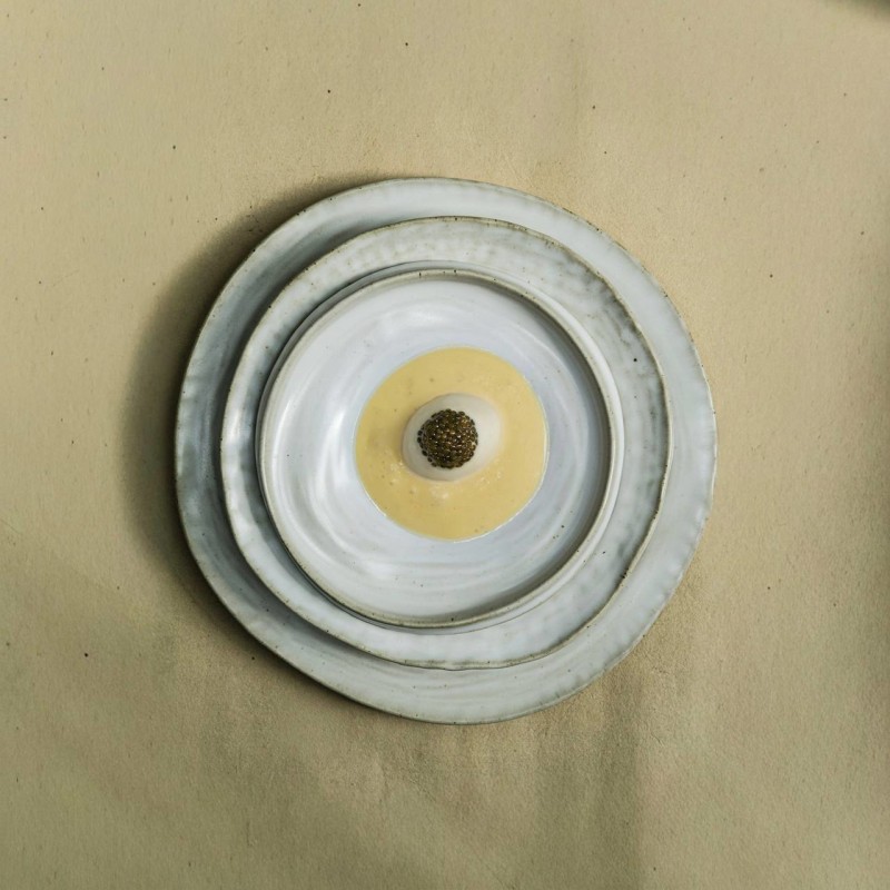 Nephele caviar served as a dessert on stacked artisan ceramics representing northwest terraced fields
