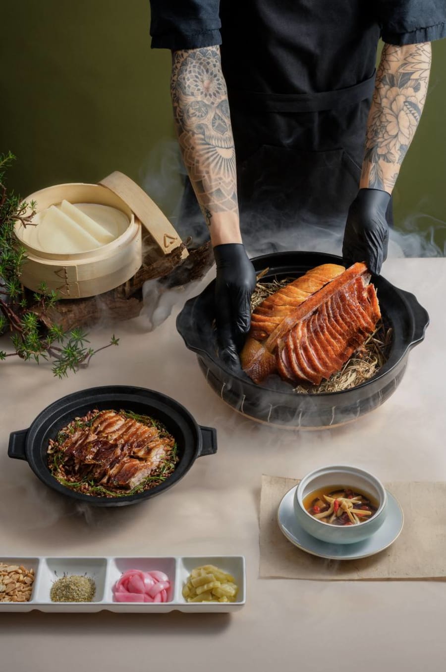 DẠ夜 signature fourteen-day dry-aged truffle roasted duck presented tableside with condiments and steamer