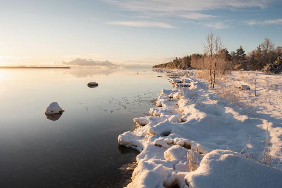 Snow-covered shoreline at golden hour on Hiiumaa island in winter