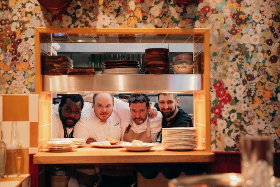 Chefs at the kitchen pass-through window at Mamie Good