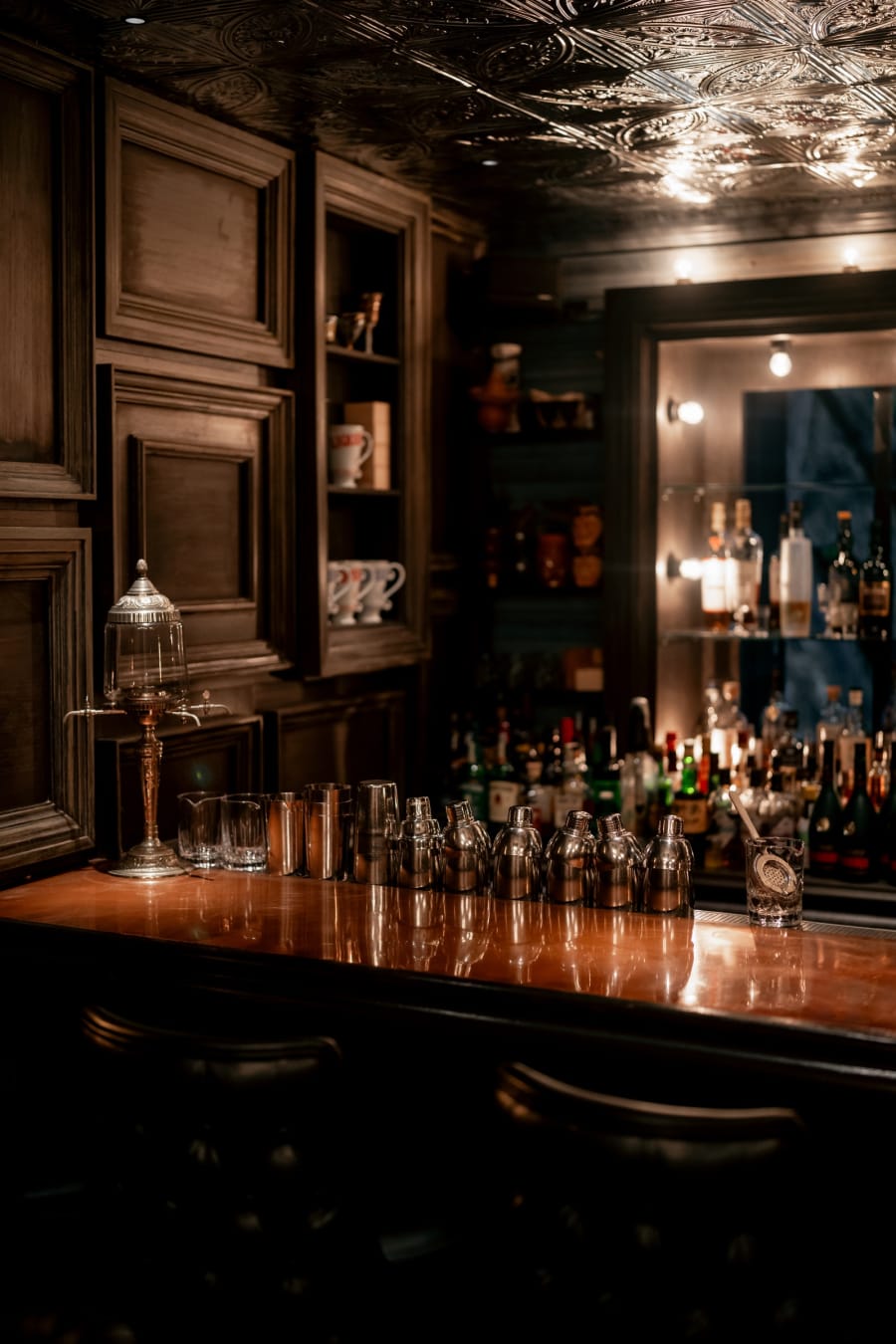 Copper-toned bar counter with cocktail shakers at Speak Low third floor