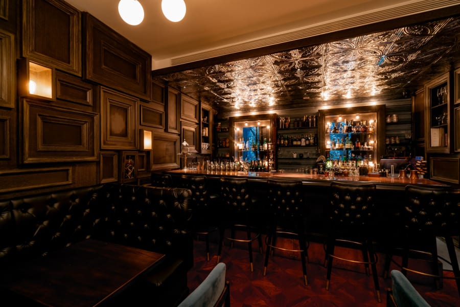 Coral-cushioned stools at the third floor bar at Speak Low