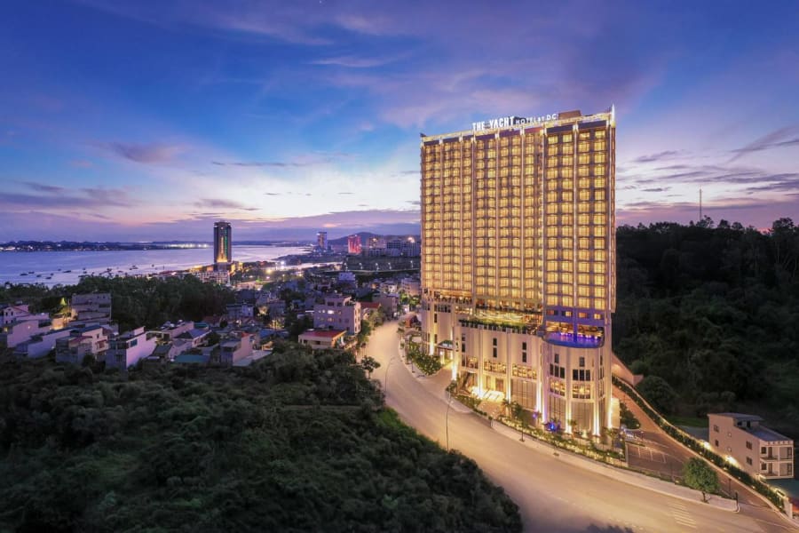 The Yacht Hotel by DC illuminated at dusk over Ha Long Bay