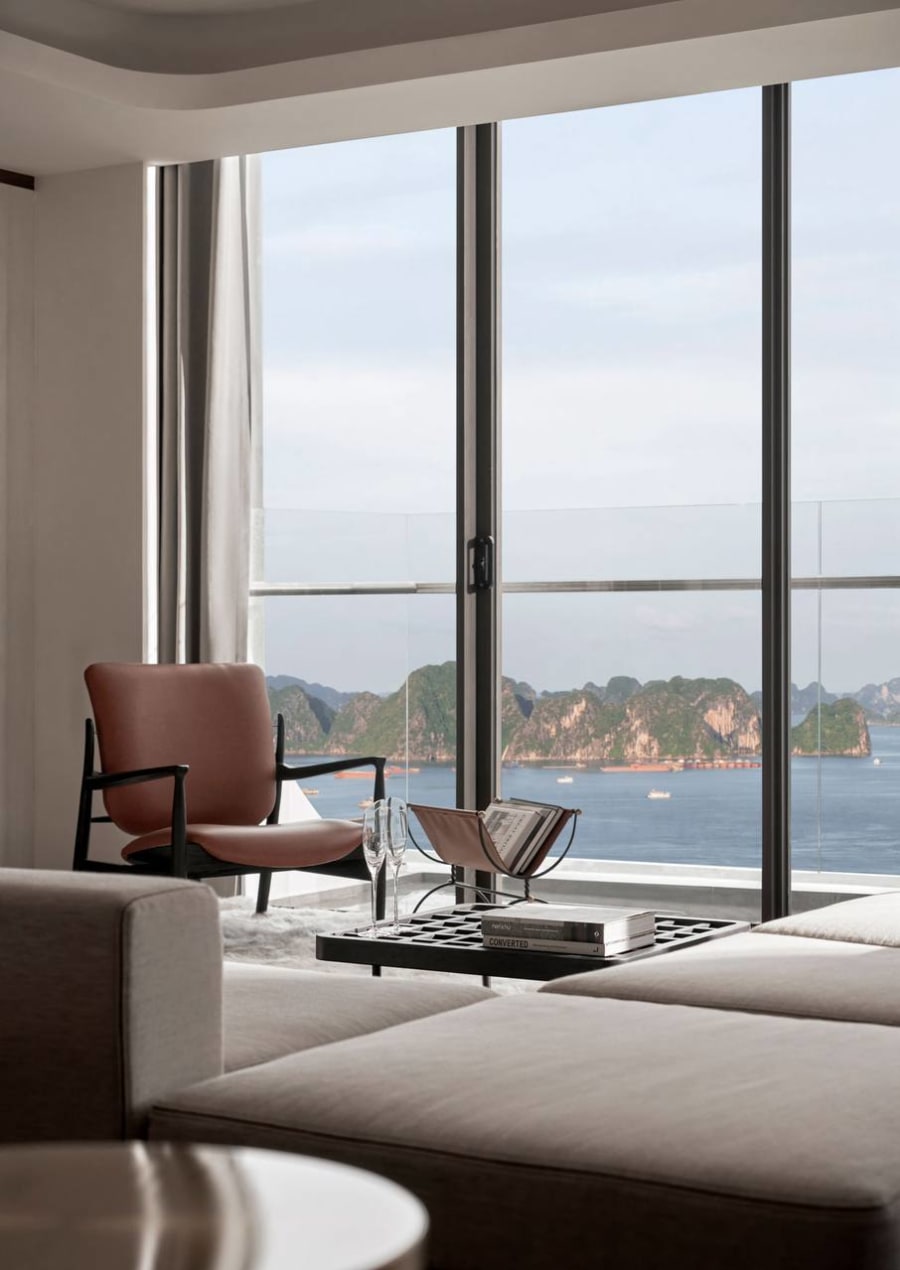 Living space with floor-to-ceiling windows overlooking limestone karsts