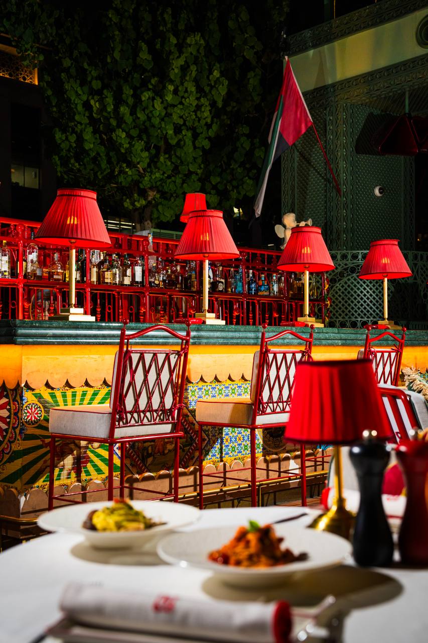 Crimson lamps and decorative Sicilian tilework at Felicità Dubai