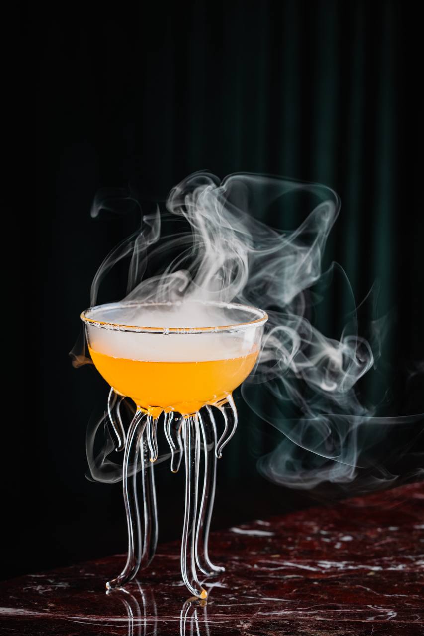 Smoky cocktail in sculptural jellyfish-inspired glassware at Felicità