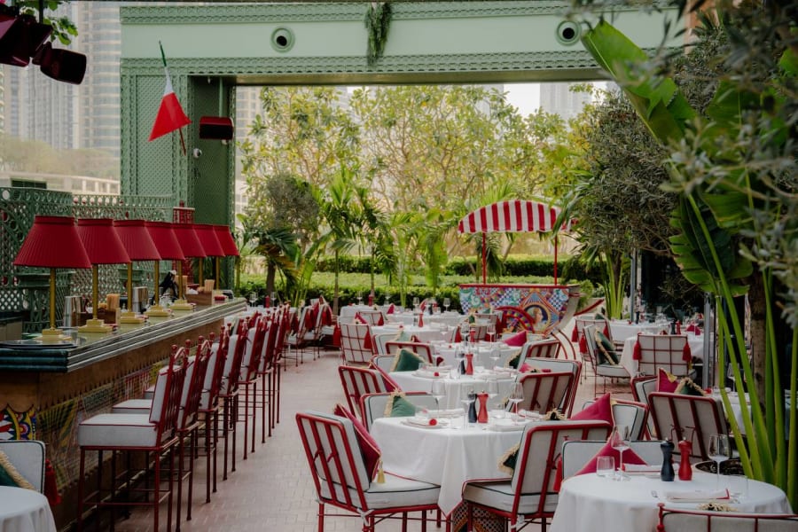 Terrace with Italian flags, white tablecloths and Burj Khalifa views at Felicità