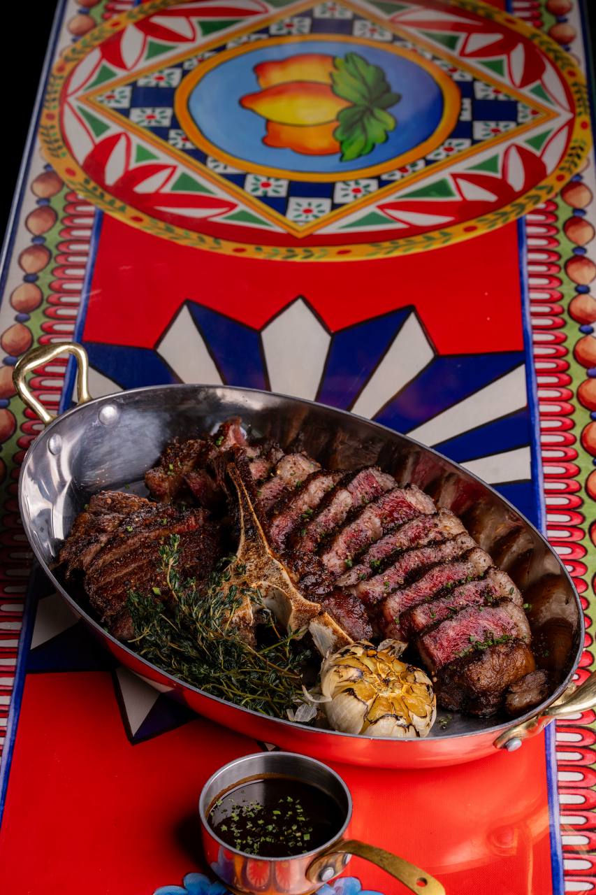 Wagyu T Bone steak with Red Wine Jus, Herb Butter and Confit Garlic at Felicità