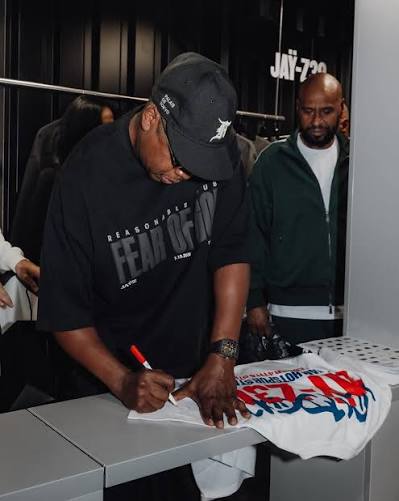 Jay-Z signing merchandise at the JAY-Z 30 pop-up in Camden, London